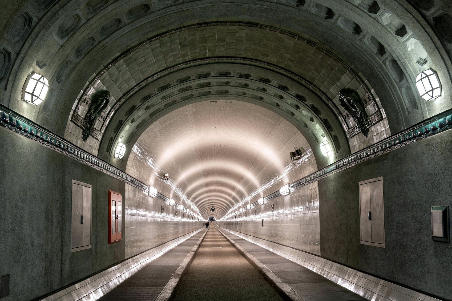 Long, illuminated tunnel stretches into the distance.